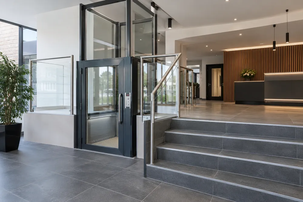 Enclosed glazed platform lift within a commercial reception